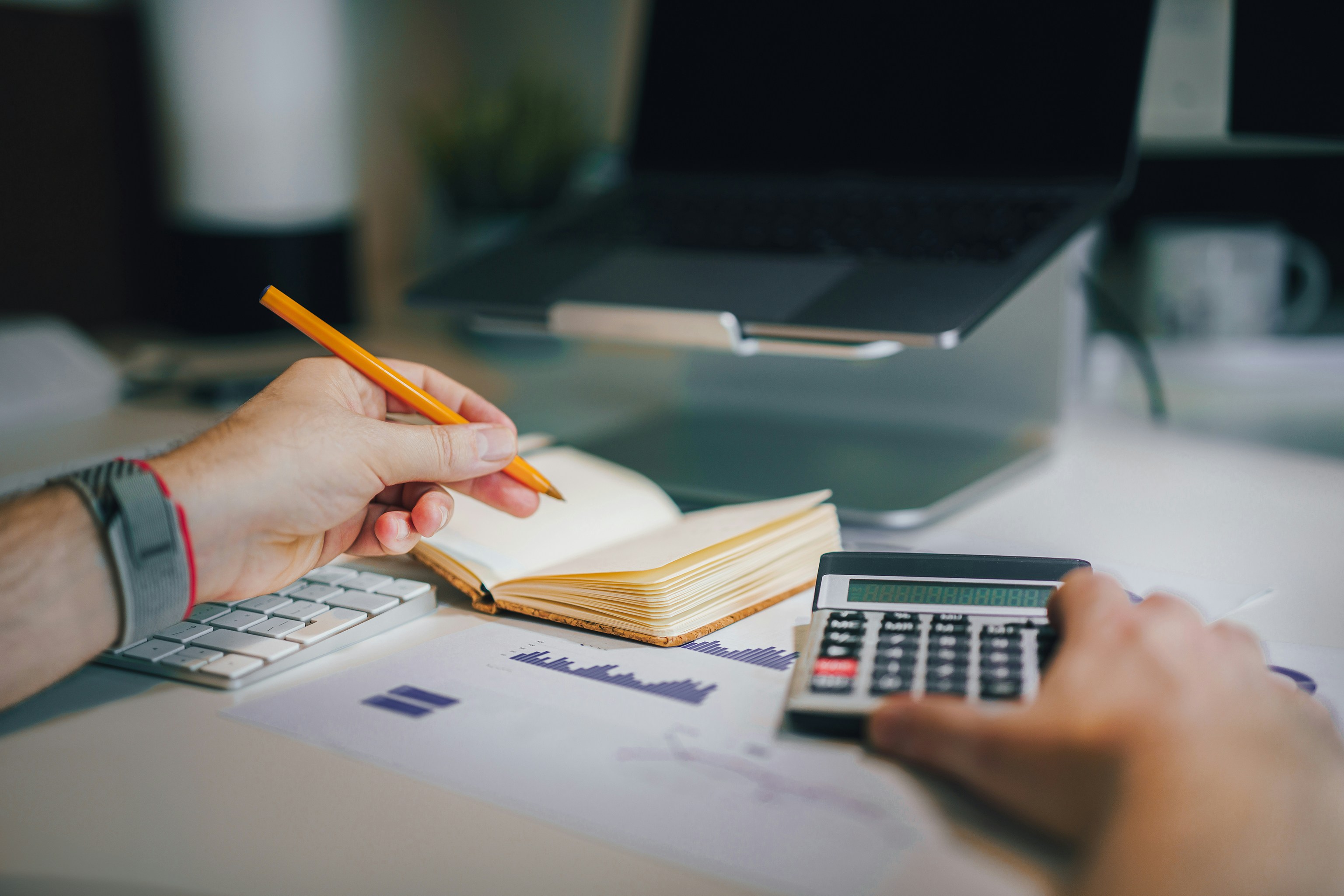 Person reviewing financial records at a desk
